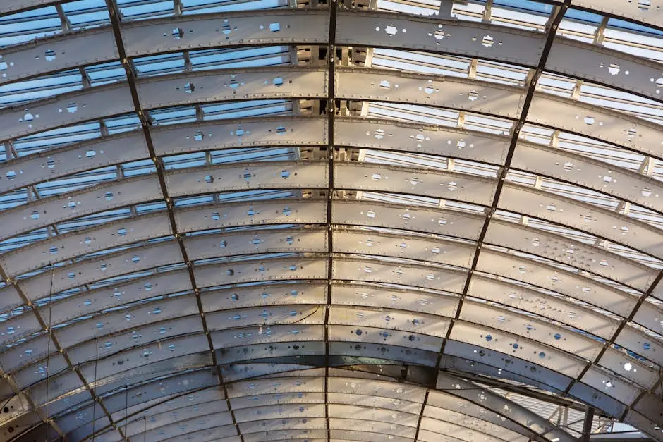 Underside of a curved perforated steel roof frame