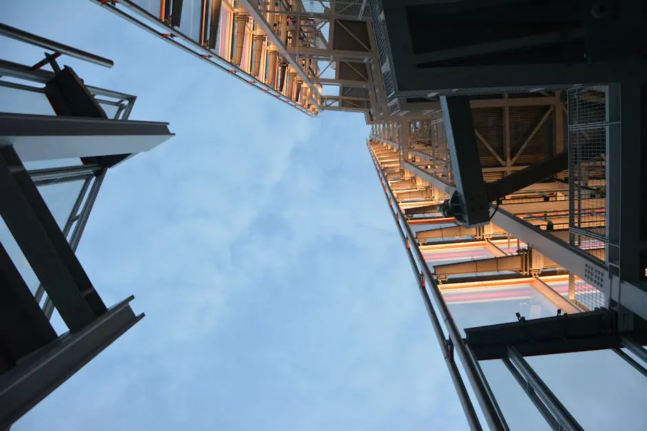 Steel frame building viewed from below against a blue sky